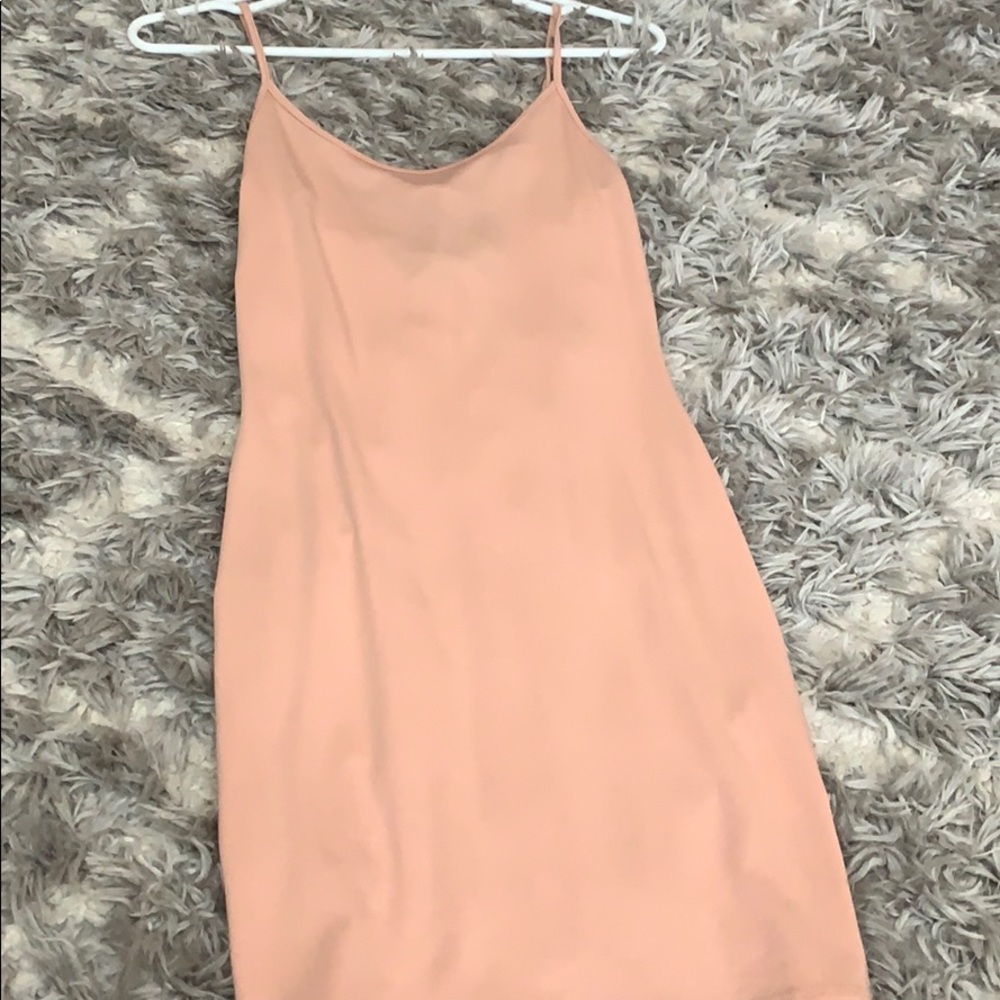 Light peach body con dress. Low in the back .